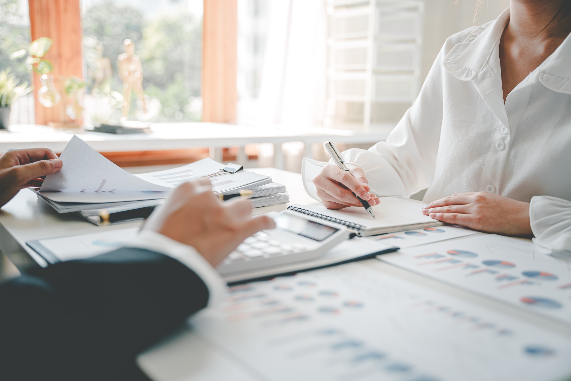 The financiers are calculating personal taxes for their customers.